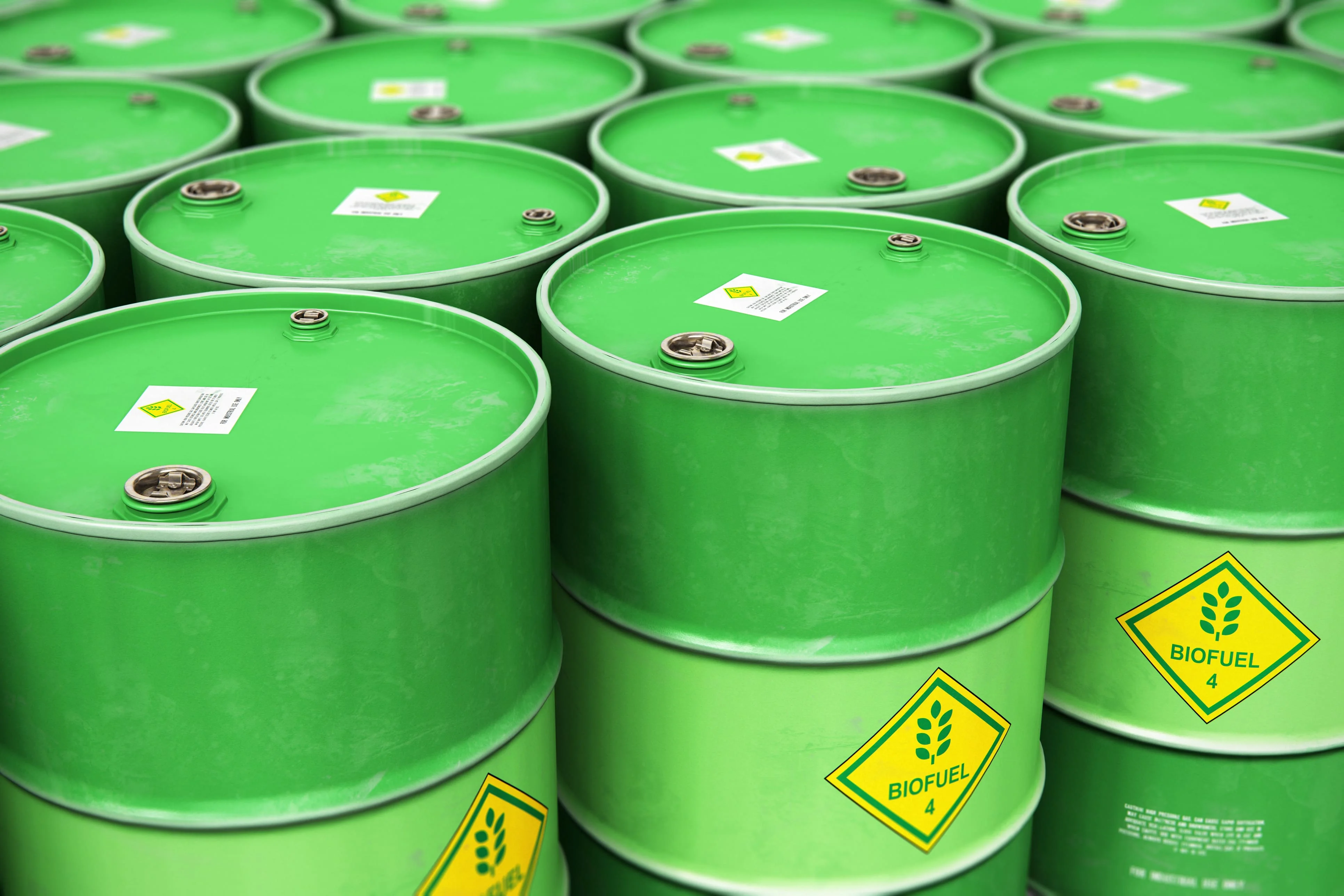 Green industrial barrels labeled biofuel stored for renewable energy and sustainable waste-to-energy applications